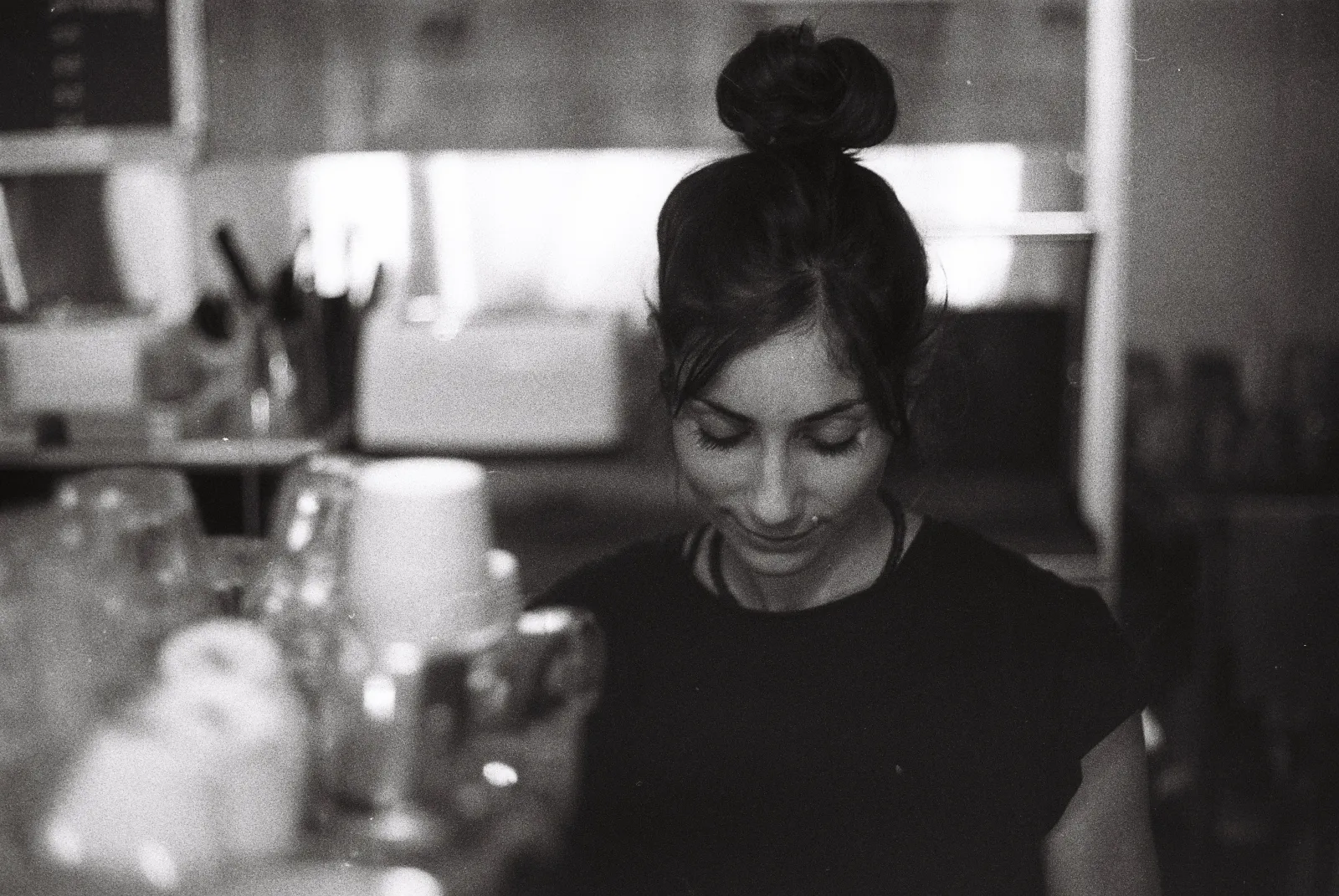 A woman making coffee with an espresso machine.